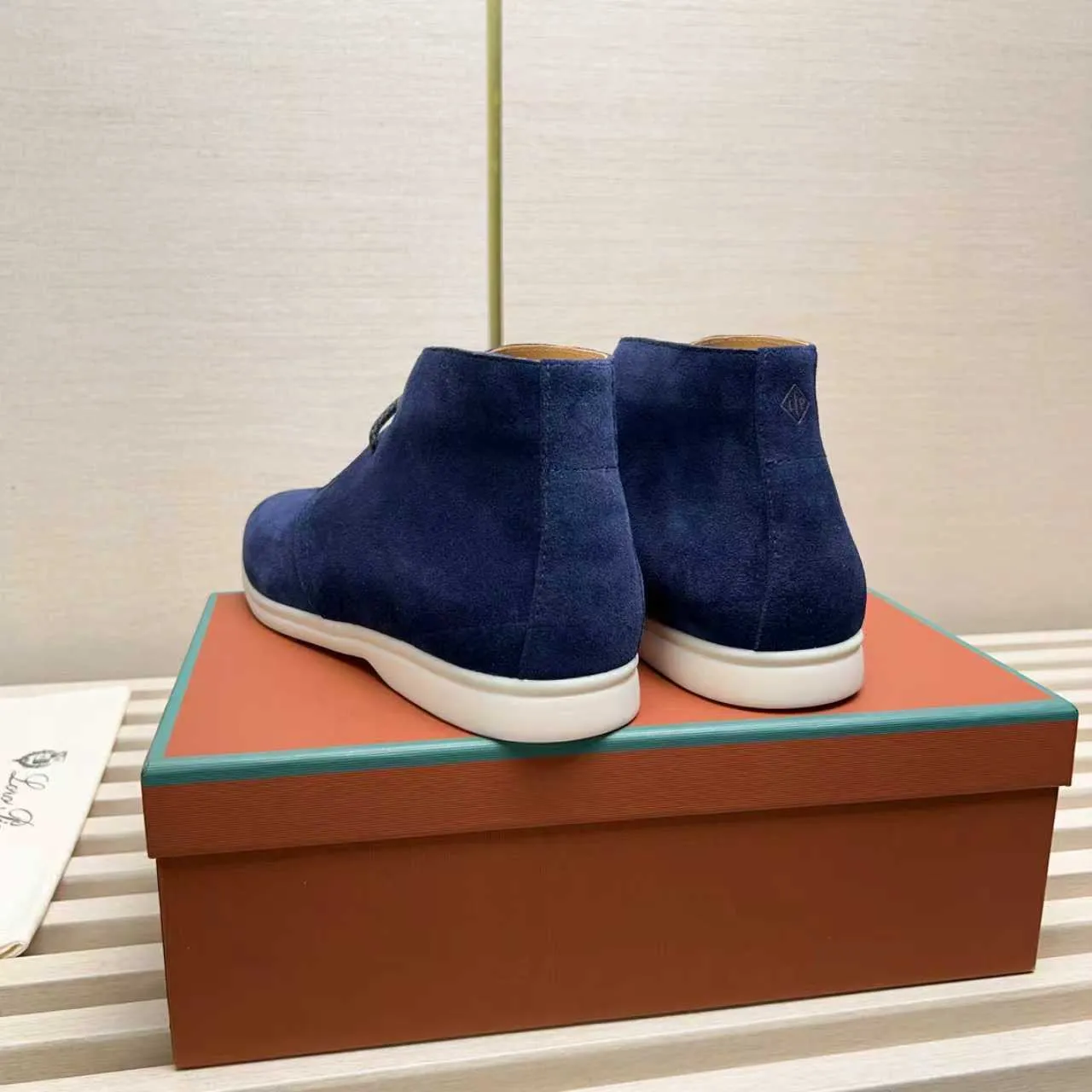 Men's Shoes 💰420 Loro Piana reimagines the desert boot—a modern, comfortable interpretation of a classic 1940s style. Crafted from suede calfskin, it exudes elegance. The tight texture of suede calfskin is not only durable but also looks casual and sophisticated. Add a timeless piece to your shoe collection, harmoniously blending comfort, style and Loro Piana's heritage of craftsmanship. Acetate satin detail on the inside White sole with LP lettering for added traction Space for a personalized signature on the heel Tonal suede trim Upper: 100% cow split suede Sole: 100% Rubber lining: Cow leather